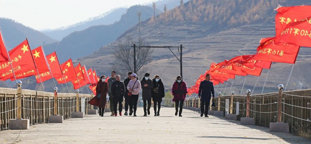 Travelers walk around China-North Korea border észak-korea kínai turisták