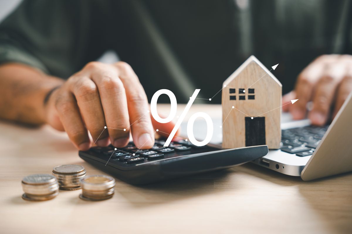 Hand,On,Calculators,,Strategizing,Home,Refinance.,Wooden,House,Model,,Buy, lakáshitel, hitel, lakás, ingatlan, számológép, házikó