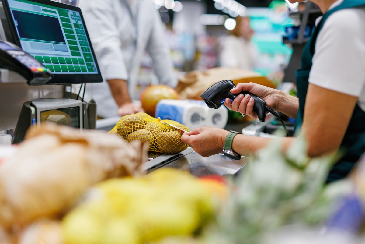 Supermarket,Cashier,Scanning,Potatoes,At,The,Checkout,Counter,,Processing,Groceries