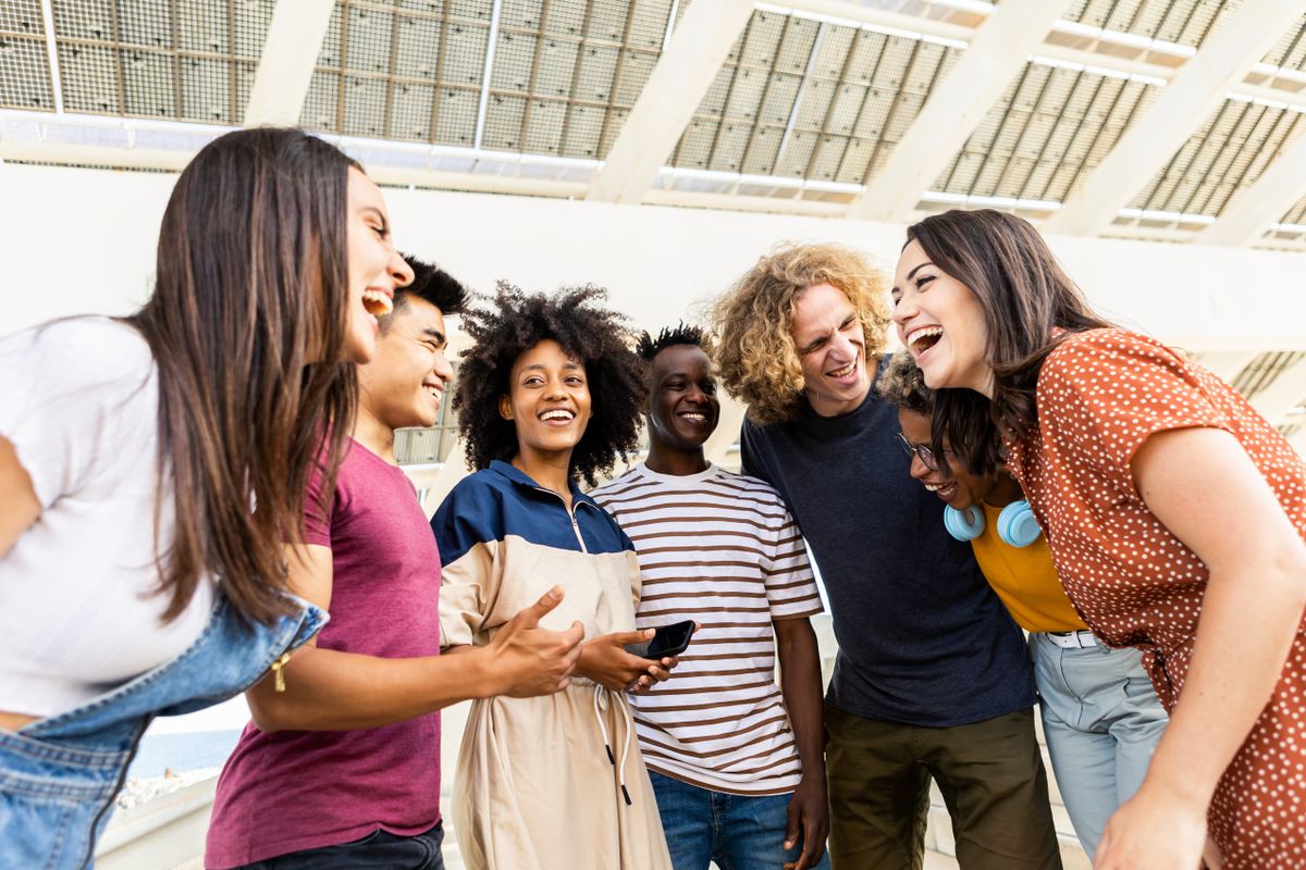 Happy,Smiling,Young,Friends,Standing,Outdoors,In,The,Street,While