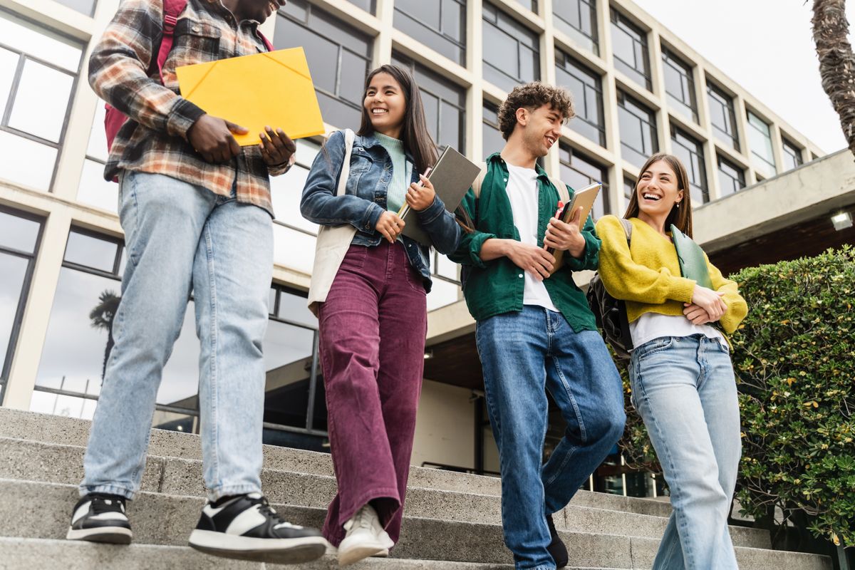 University,Students,Walking,College,Staircase,Holding,Books,And,Laughing,,After