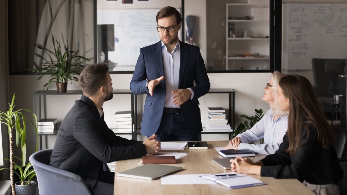 Serious,Young,Business,Leader,Man,Holding,Meeting,With,Managers.,Colleagues
