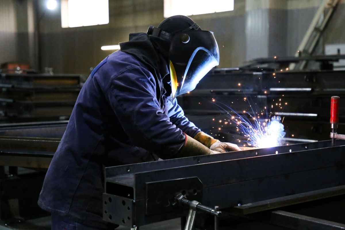 Skilled,Welder,In,Protection,At,Work,With,Sparks,Flying,In