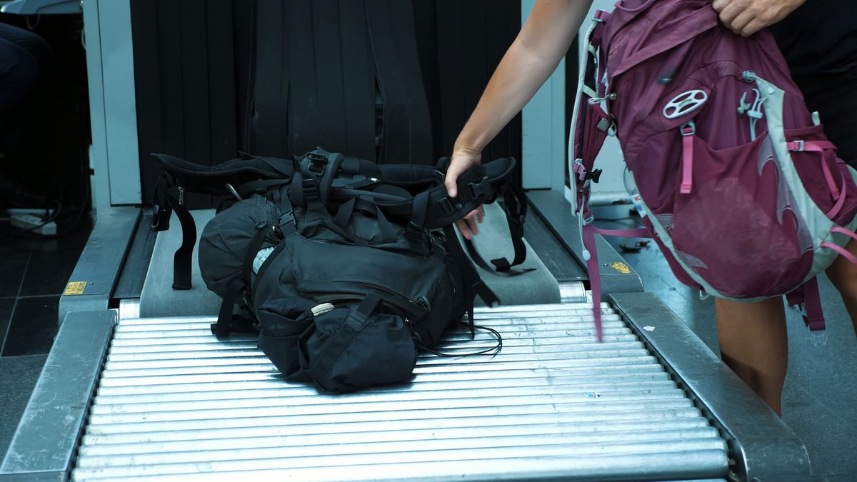 close-up. passengers take their bags, Baggage from conveyor belt, after they have passed x-ray luggage scanner, check at airport