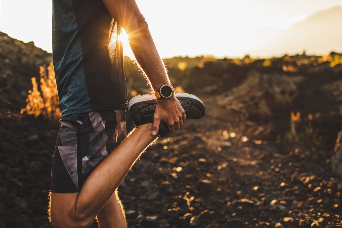 Runner stretching leg and preparing for running