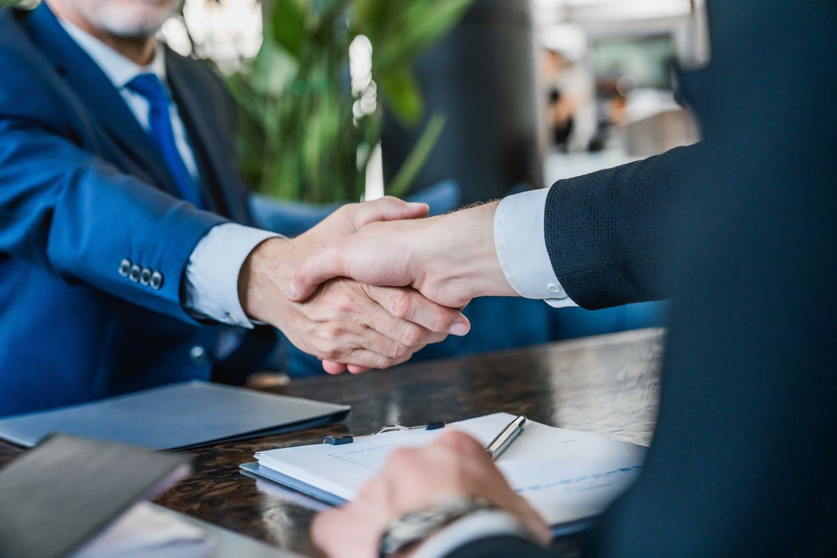 Close,Up,Shot,Of,Businessmen,Making,Handshake,With,Partner,,Greeting,