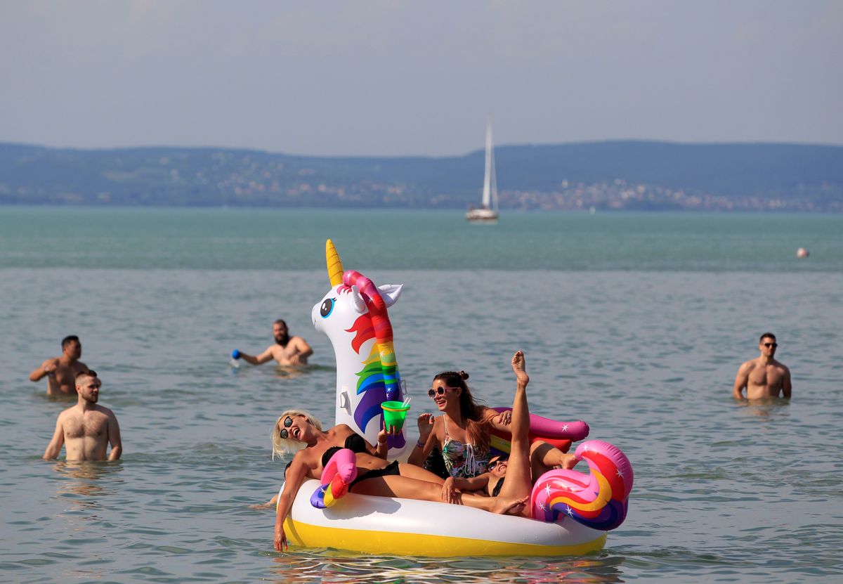 Festival goers lie on an air mattress in Lake Balaton during the Balaton Sound music festival in Zamardi