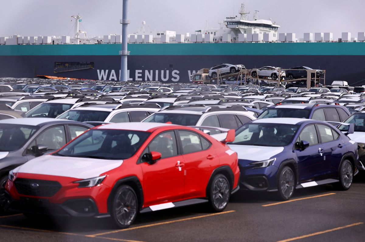 Newly manufactured cars awaiting export are parked at a port in Yokohama