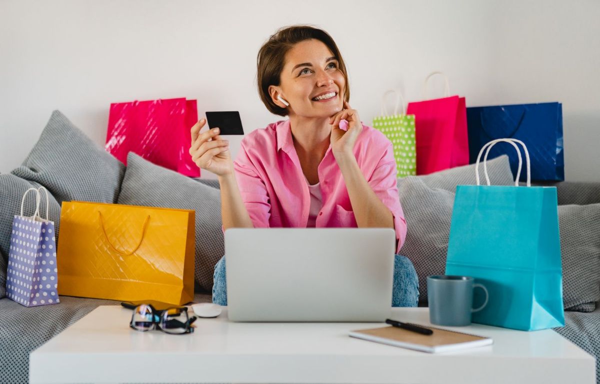 paypal happy smiling woman in pink shirt on sofa at home shopping online