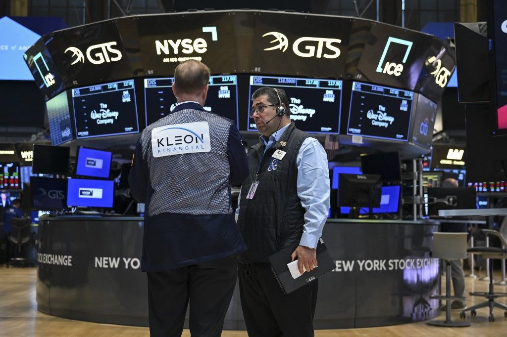 Traders work on the floor of the New York Stock Exchange (NYSE) at the opening bell