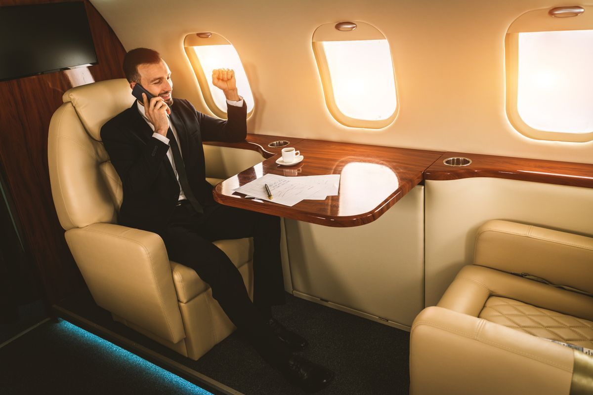 Handsome,Businessman,Wearing,Elegant,Suit,Flying,On,Exclusive,Private,Jet