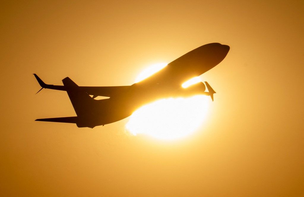 Airplane in front of the sun