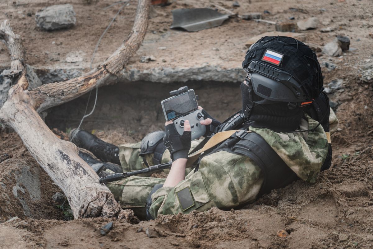 Uav,Operator,With,A,Remote,Control,Sitting,In,A,Trench.