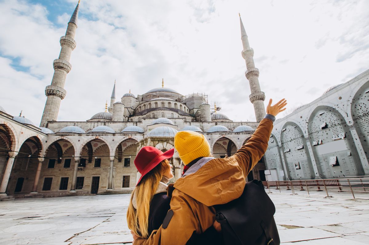 A,Young,European,Couple,Walks,In,The,Courtyard,Of,The
