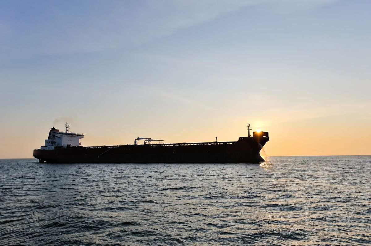 Crude,Oil,Tanker,In,The,Sea,At,Sunset.