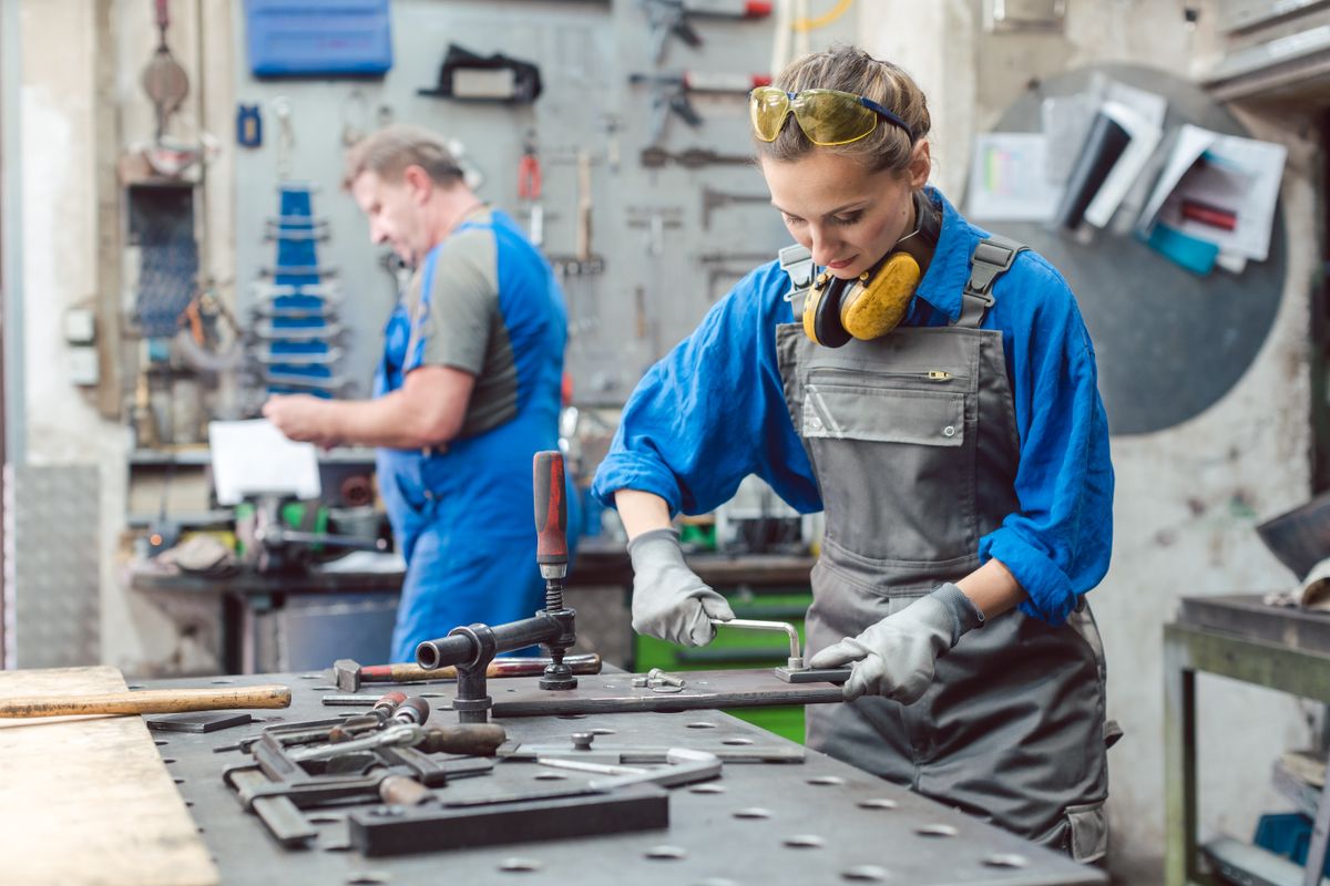 Man,And,Woman,Working,Together,In,Metal,Workshop,With,Their
