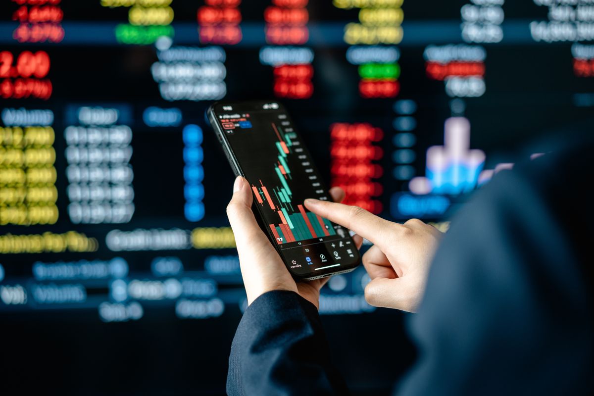 Investors,Analyze,The,Data,Stock,Market,Index,Via,Smartphone,Screen