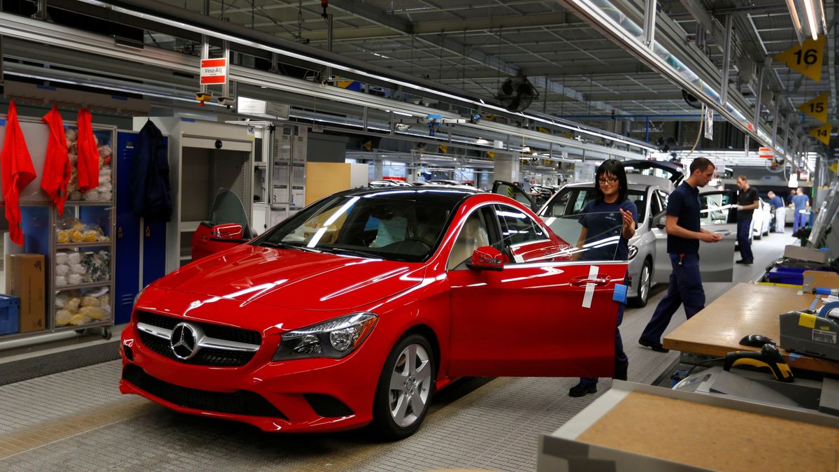 Factory worker inspects cars on the assembly line at Daimler's Mercedes factory in Kecskeme