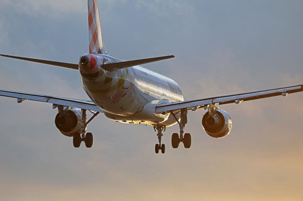 Aircraft land at Barcelona airport at sunset