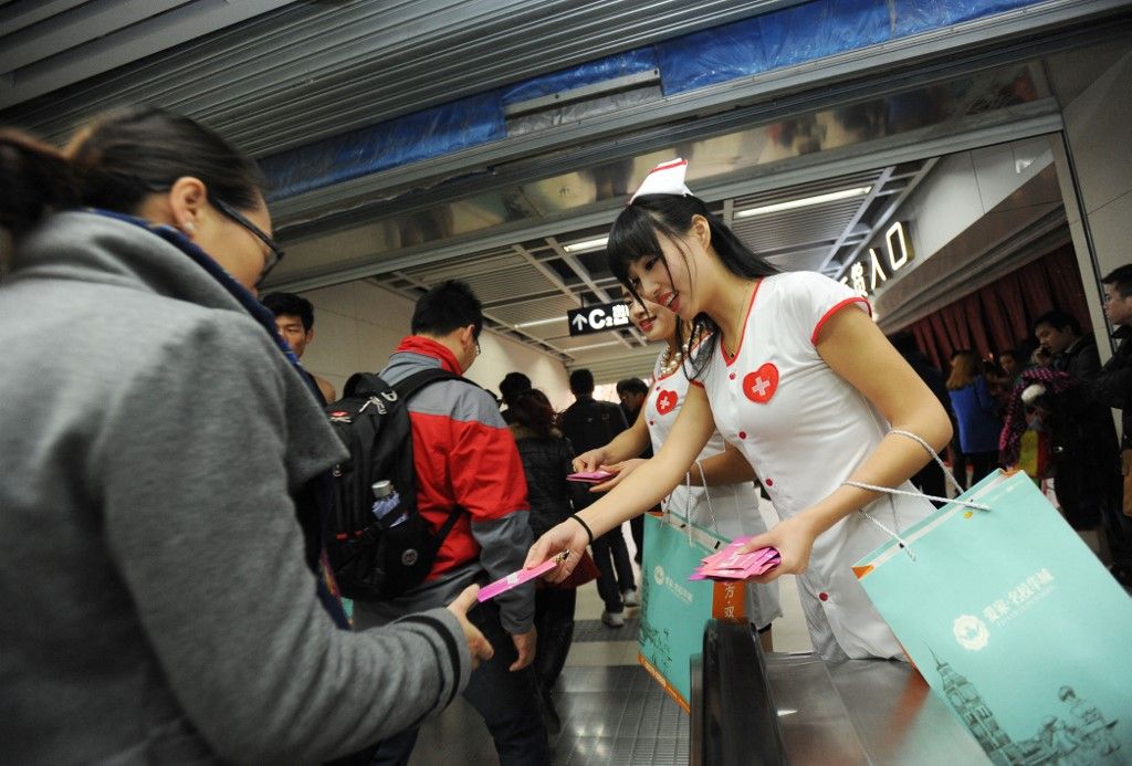Young men and women sexy up subway train to promote World AIDS Day in Central China