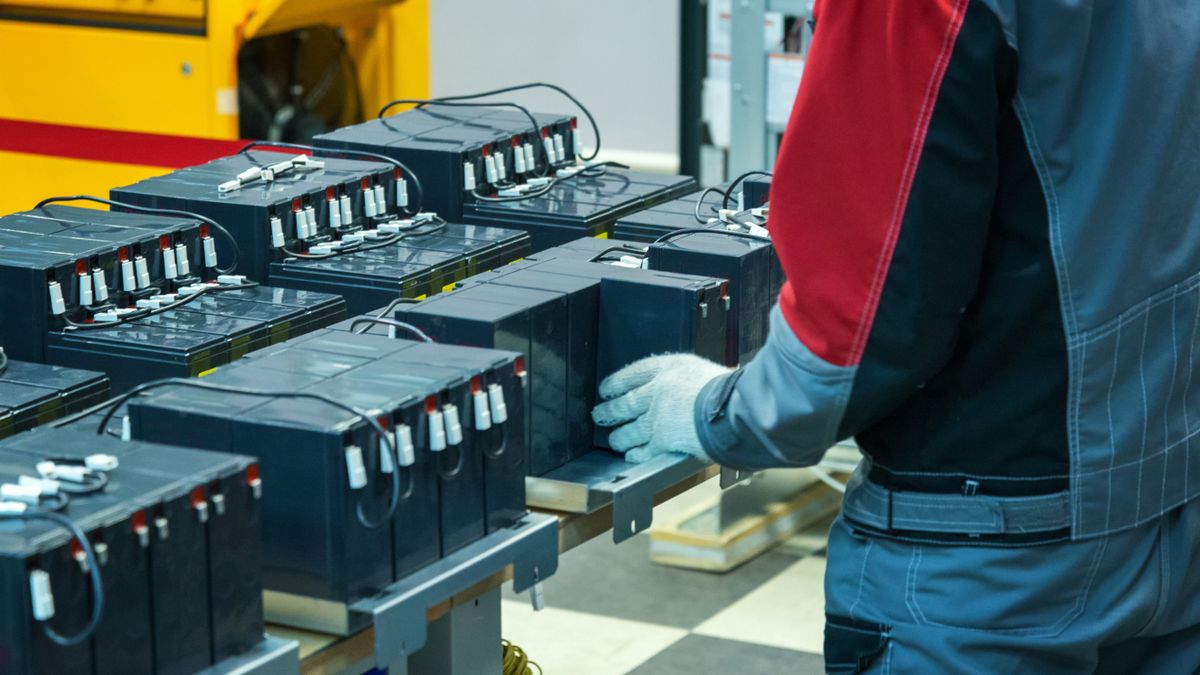 Debrecen,A,Gloved,Worker,Connects,The,Batteries,To,The,Factory