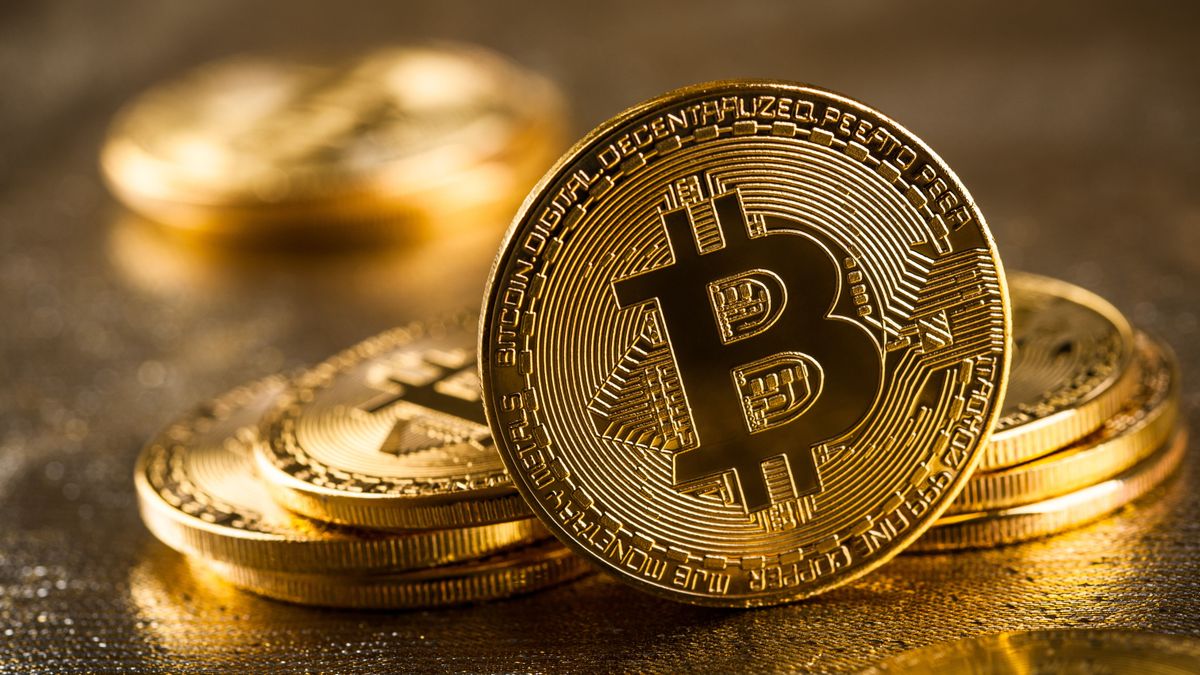 Gold,Bitcoins,On,Glittering,Background,,Close,Up