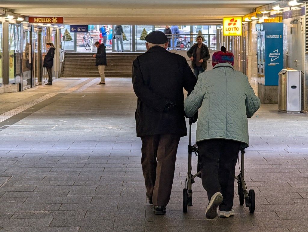 Senior Couple Using A Walker
