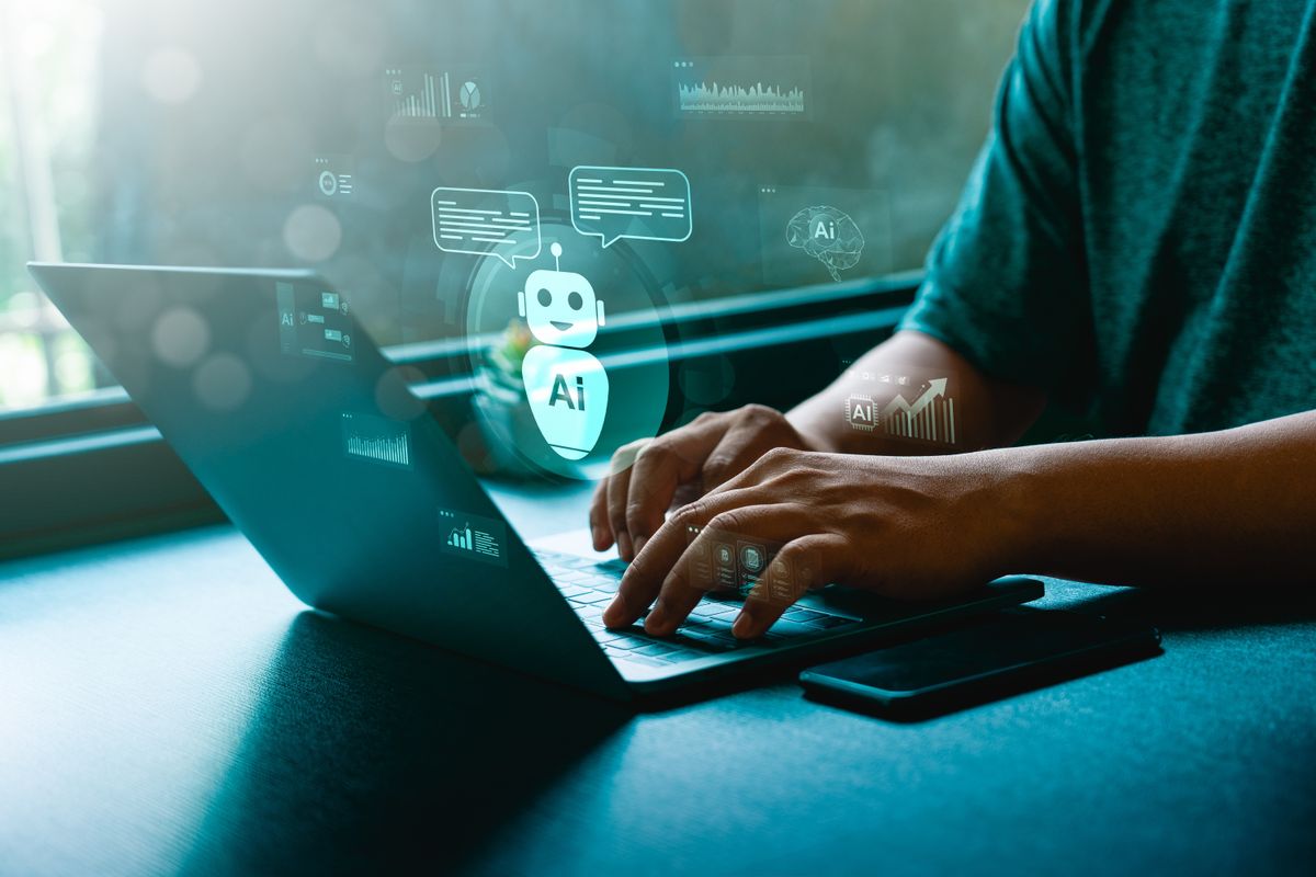 Businessman,Typing,On,Laptop,With,Ai,Chatbot,Hologram,Interface,,Symbolizing