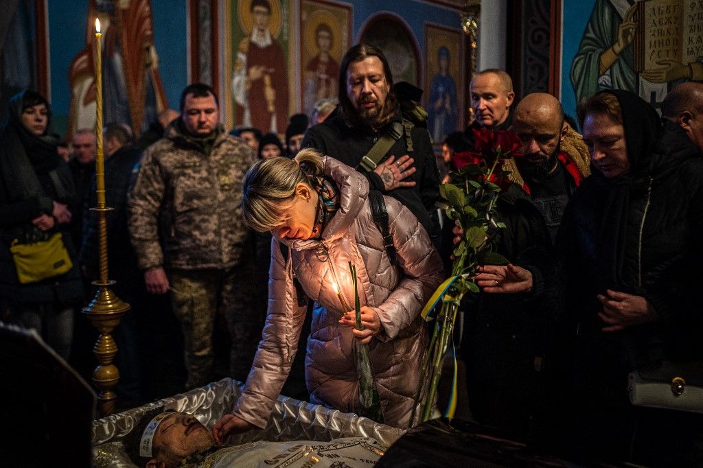 (FILES) Mourners bid farewell to Denys Galushko, a Ukrainian serviceman killed while fighting against Russian troops in Bakhmut, during his funeral at the Orthodox Saint Michael's Golden-Domed Monastery in Kyiv on January 12, 2023, amid the Russian invasi