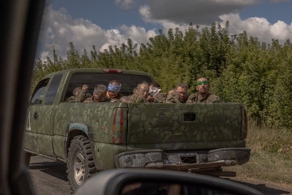 (FILES) A Ukrainian military vehicle drives from the direction of the border with Russia carrying blindfolded men in Russian military uniforms, in the Sumy region, on August 13, 2024, amid the Russian invasion of Ukraine. On August 6, 2024, Ukraine launch