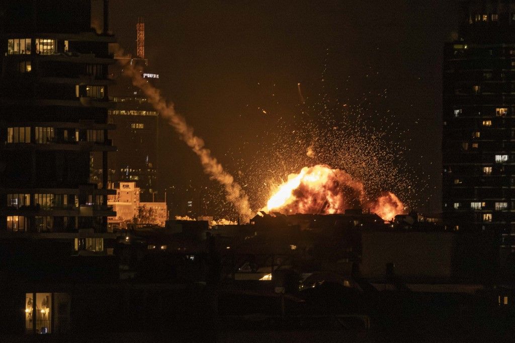 A fireball lights the sky following a missile strike on Tel Aviv on February 28, 2026. The United States and Israel launched strikes against Iran on February 28, with Israel's public broadcaster reporting that the Iranian supreme leader had been targeted,