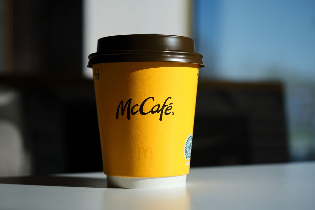 A,Yellow,Paper,Cup,With,The,Logo,Of,A,Famous, per