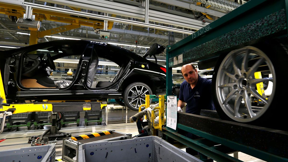 Factory worker assambles car on the assembly line at Daimler's Mercedes factory in Kecskeme 