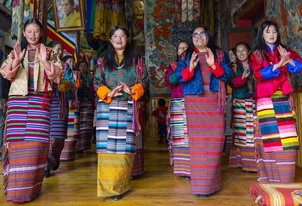 BHUTAN - BHUTANESE WOMEN DANCING DURING URA YAKCHOE IN THE TEMPLE - URA