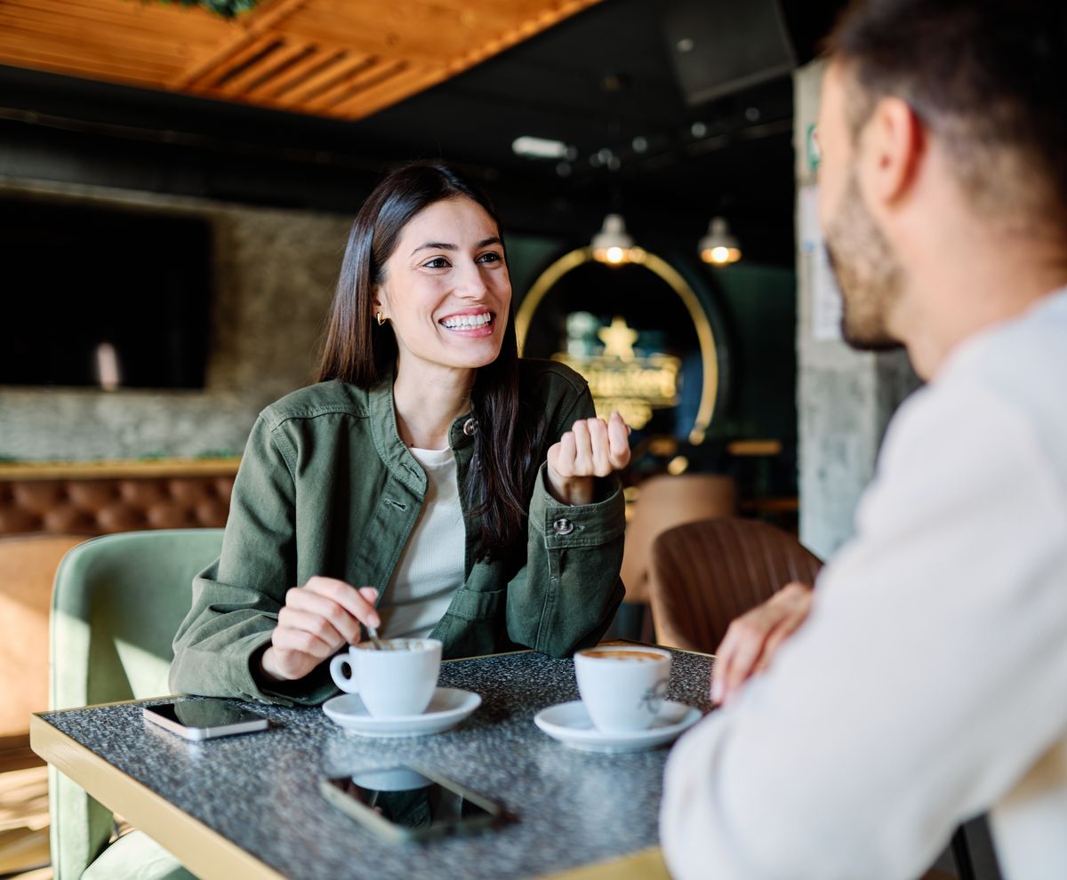 Young,Couple,Enjoying,Conversation,And,Coffee,Together,At,An,Urban