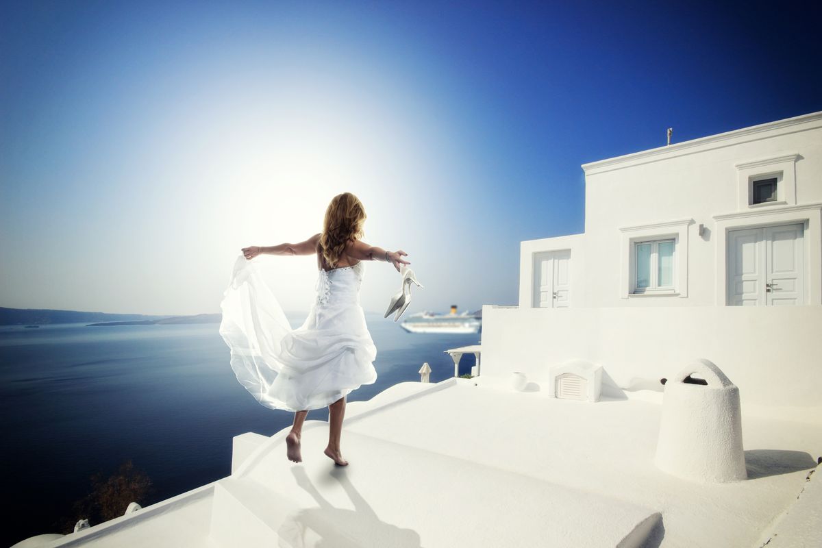 Bride,In,White,Wedding,Dress,At,Sunset,In,Santorini,Greece