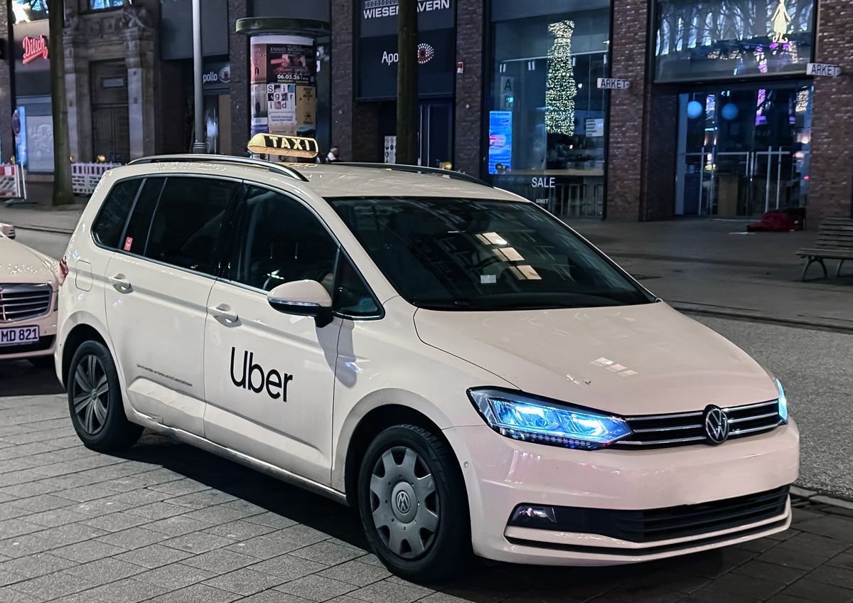 White Uber taxi parked on city street Hamburg, Germany