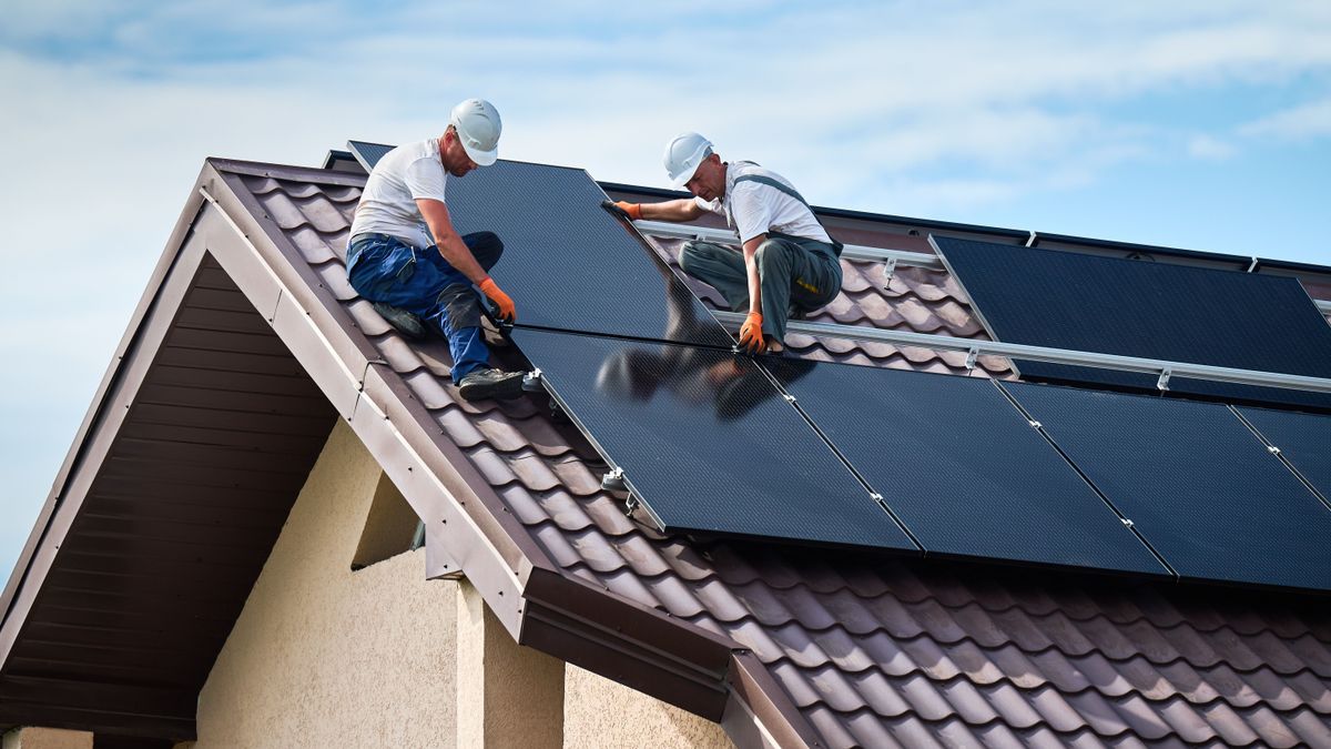 Workers,Building,Solar,Panel,System,On,Rooftop,Of,House.,Two Program