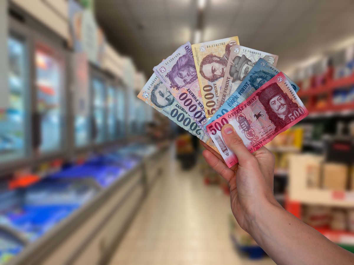Hungarian,Forints,In,Hand,And,Grocery,Store,In,The,Background. forint