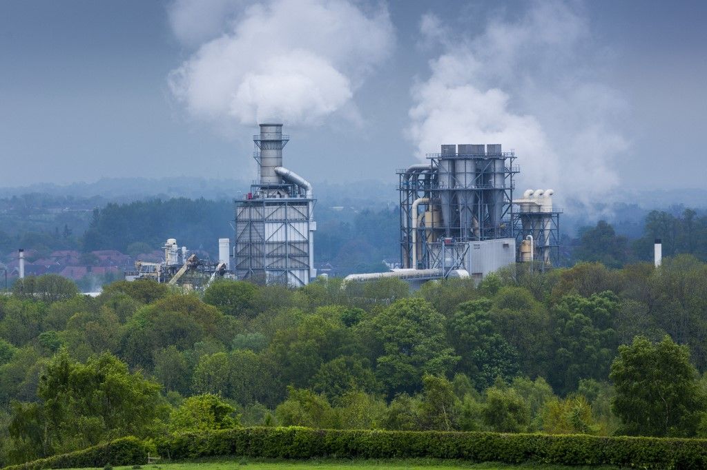 Steaming smoke stacks at Kronospan Factory making wood based panels, chipboard and MDF at Chirk in Wrexham, Wales, United Kingdom, Europe